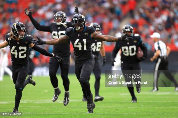 Josh Allen of the Jacksonville Jaguars celebrates after a fumble by Desmond Ridder of the Atlanta Falcons and a recovery to win the game in the...