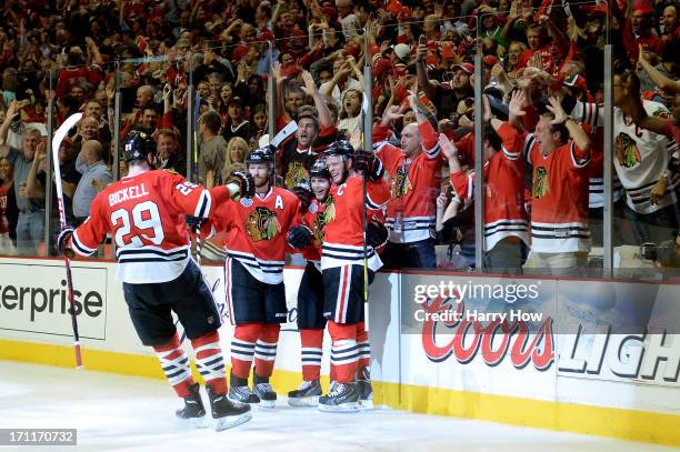 Patrick Kane of the Chicago Blackhawks celebrates with Jonathan Toews, Bryan Bickell and Duncan Keith after he scored a goal in the second period...