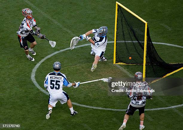 Eric Law of the Denver Outlaws scores past Brian Phipps of the Ohio Machine as Chad Wiedmaier and Brendan Mundorf look on during the second quarter...