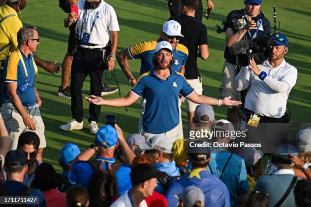 Tommy Fleetwood of Team Europe celebrates the Ryder Cup victory with 16 and a half to 11 and a half win following the during the Sunday singles...