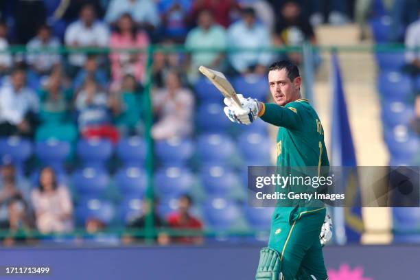 South Africa's Quinton De Kock celebrates after scoring a hundred during the ICC Men's Cricket World Cup 2023 match between South Africa and Sri...