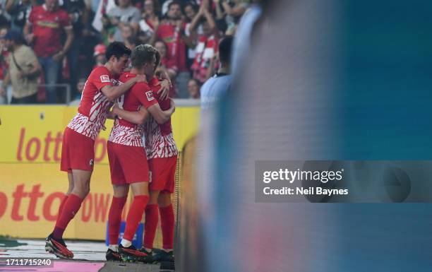 Philipp Lienhart of Sport-Club Freiburg celebrates with teammates after scoring the team's second goal during the Bundesliga match between Sport-Club...