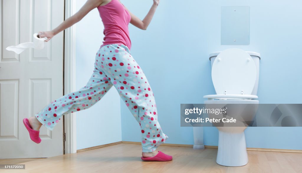 Woman running to toilet in night clothes