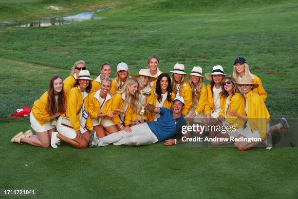 Viktor Hovland of Team Europe poses for a photograph with the Ryder Cup trophy alongside the partners of Team Europe following the Sunday singles...