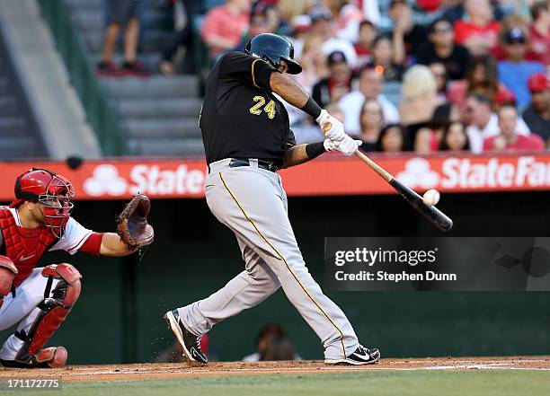 Pedro Alvarez of the Pittsburgh Pirates hits a solo home run in the second inning against the Los Angeles Angels of Anaheim at Angel Stadium of...