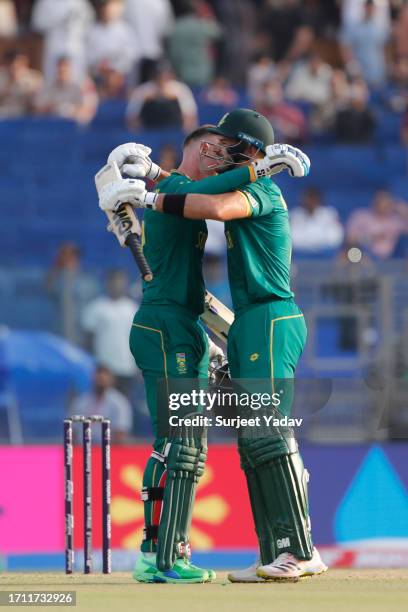 Rassie Van Der Dussen of the South Africa celebrates after scoring a century with Aiden Markram of the South Africa during the ICC Men's Cricket...