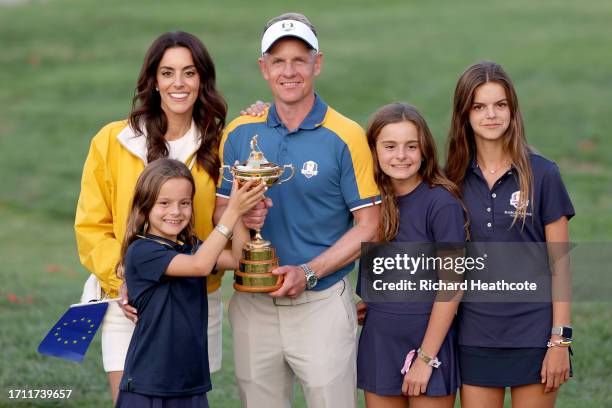 Luke Donald, Captain of Team Europe poses for a photograph with the Ryder Cup trophy alongside his wife Diane Donald and children Elle Donald, Sophia...