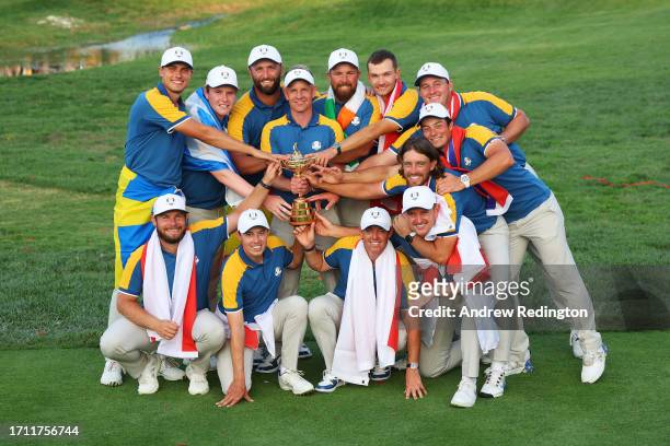 Luke Donald, Captain of Team Europe and players of Team Europe pose with the Ryder Cup trophy following victory with 16 and a half to 11 and a half...