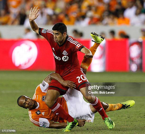 Ricardo Clark of Houston Dynamo and Matias Laba of Toronto FC get tangled up fighting for possesion of the ball in the second half at BBVA Compass...