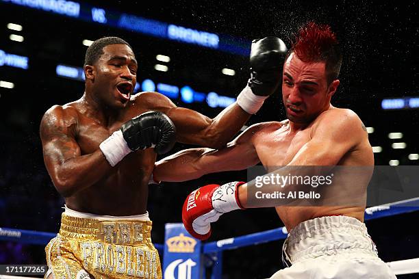 Adrien Broner lands a left on Paulie Malignaggi during their WBA Welterweight Title bout at Barclays Center on June 22, 2013 in the Brooklyn borough...