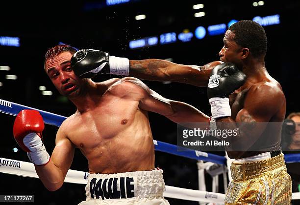 Adrien Broner lands a right on Paulie Malignaggi during their WBA Welterweight Title bout at Barclays Center on June 22, 2013 in the Brooklyn borough...
