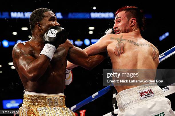 Paulie Malignaggi and Adrien Broner exchange blows during their WBA Welterweight Title bout at Barclays Center on June 22, 2013 in the Brooklyn...