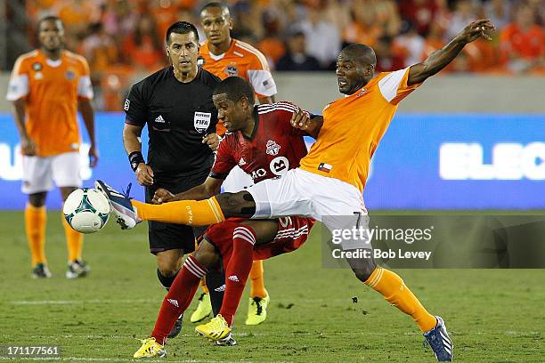 Omar Cummings of Houston Dynamo reaches for the ball as Jeremy Hall of Toronto FC defends in the second half at BBVA Compass Stadium on June 22, 2013...