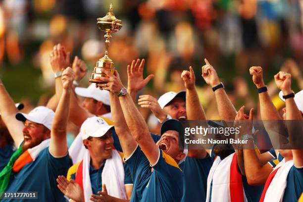 Team Europe Captain Luke Donald lifts the trophy with his team after his team win during the Sunday singles matches of the 2023 Ryder Cup at Marco...