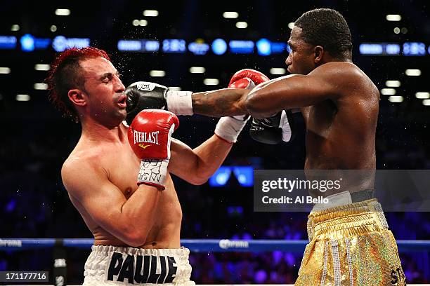 Adrien Broner lands a punch on Paulie Malignaggi during their WBA Welterweight Title bout at Barclays Center on June 22, 2013 in the Brooklyn borough...