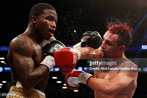 Paulie Malignaggi and Adrien Broner exchange blows during their WBA Welterweight Title bout at Barclays Center on June 22, 2013 in the Brooklyn...