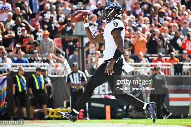 Lamar Jackson of the Baltimore Ravens celebrates while scoring a rushing touchdown during the first quarter against the Cleveland Browns at Cleveland...