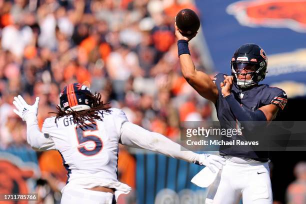 Justin Fields of the Chicago Bears passes the ball over Randy Gregory of the Denver Broncos at Soldier Field on October 01, 2023 in Chicago, Illinois.
