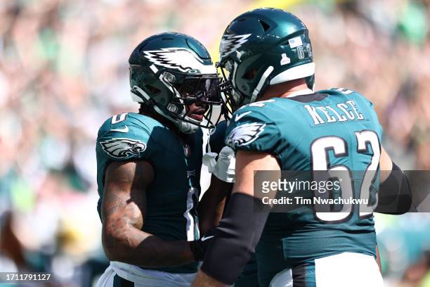 Andre Swift and Jason Kelce of the Philadelphia Eagles celebrate a touchdown by Swift during the second quarter against the Washington Commanders at...
