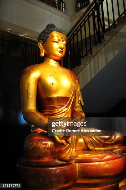 Ch'ing Dynasty gilded wood Buddha carved for a summer palace in Northern China greets shoppers as they enter the Gumps's store in San Francisco,...