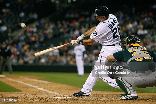 Raul Ibanez of the Seattle Mariners hits a three-run homer in the seventh inning against the Oakland Athletics at Safeco Field on June 22, 2013 in...