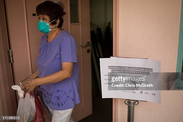 Woman leaves a distribution center where free N95 masks were being given out at the Ang Mo Kio Community Center on June 23, 2013 in Singapore....