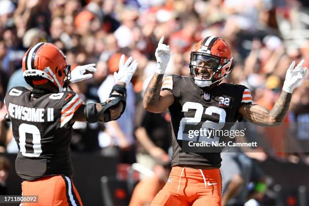 Greg Newsome II of the Cleveland Browns and Grant Delpit of the Cleveland Browns celebrate a tackle for loss during the second quarter against the...