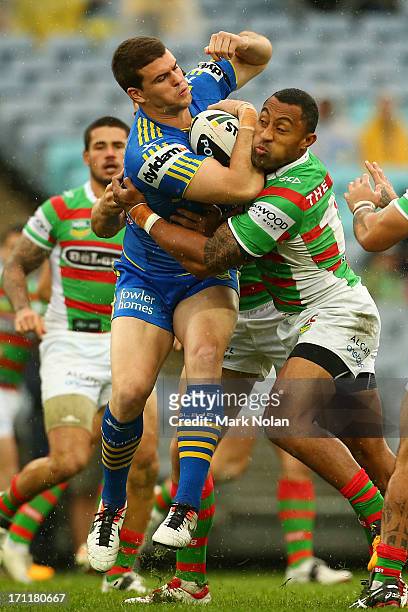 Darcy Lussick of the Eels is tackled by Roy Asotasi of the Rabbitohs during the round 15 NRL match between the Parramatta Eels and the South Sydney...