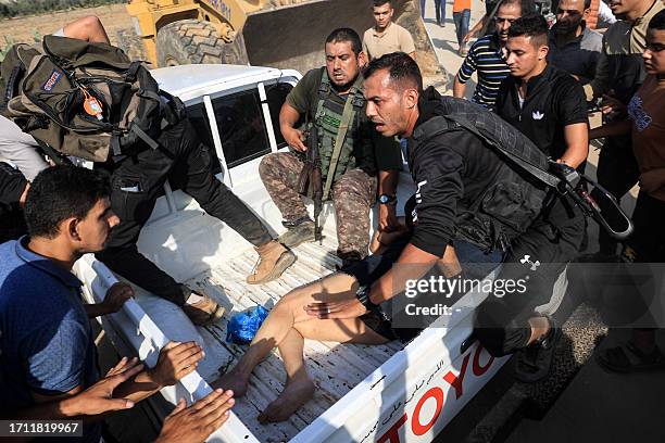 Graphic content / Palestinian militants surround a truck reportedly carrying a captured Israeli woman, in Khan Yunis in the southern Gaza Strip, on...