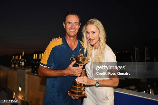 Nicolas Colsaerts, Vice Captain of Team Europe poses for a photograph with the Ryder Cup trophy alongside wife Rachel Colsaerts following the Sunday...