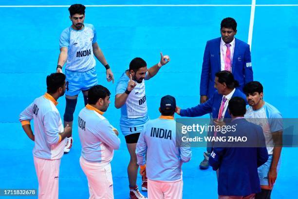 India players argue with referees on a disputed decision in the men's kabaddi gold medal match between India and Iran during the Hangzhou 2022 Asian...