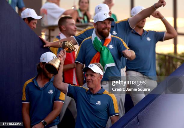 Luke Donald, Captain of Team Europe lifts the Ryder Cup trophy following victory with 16 and a half to 11 and a half win during the Sunday singles...