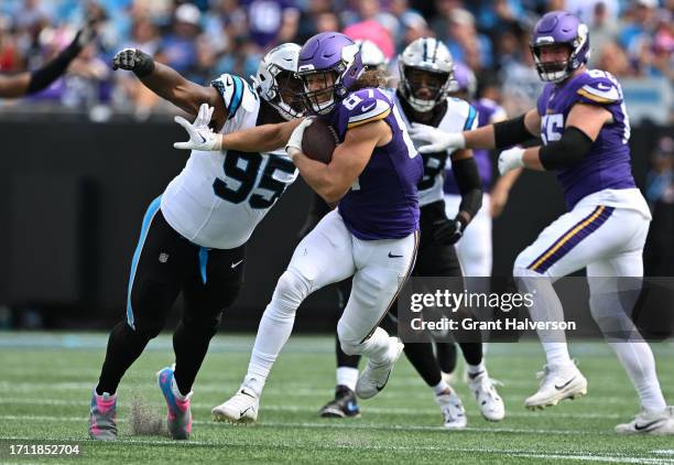 Hockenson of the Minnesota Vikings runs against Derrick Brown of the Carolina Panthers during second quarter at Bank of America Stadium on October...