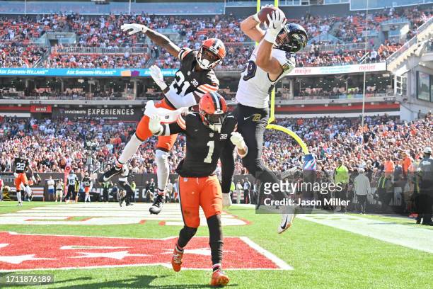 Mark Andrews of the Baltimore Ravens catches a touchdown pass over Denzel Ward of the Cleveland Browns and Juan Thornhill of the Cleveland Browns...