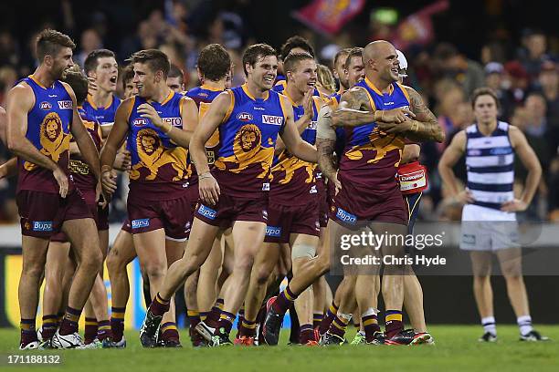 Ashley McGrath of the Lions celebrates with team mates after kicking the winning goal during the round 13 AFL match between the Brisbane Lions and...