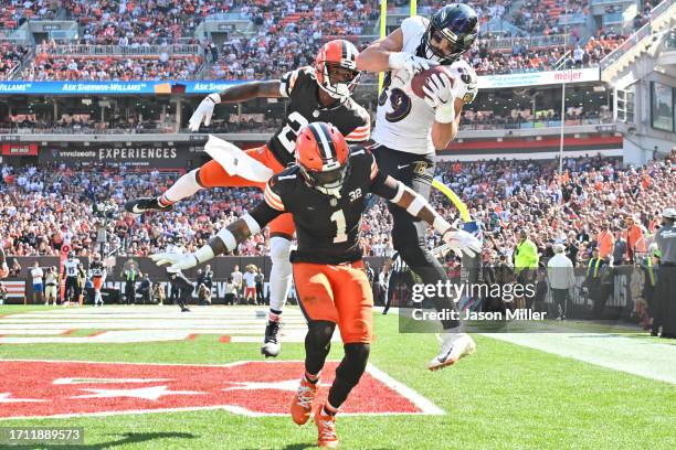 Mark Andrews of the Baltimore Ravens catches a touchdown pass over Denzel Ward of the Cleveland Browns and Juan Thornhill of the Cleveland Browns...