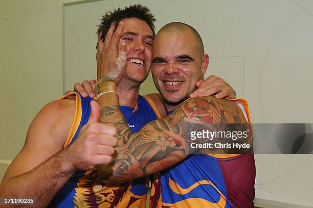 Simon Black and Ashley McGrath of the Lions celebrate winning the round 13 AFL match between the Brisbane Lions and the Geelong Cats at The Gabba on...