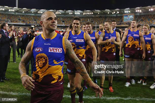 Ashley McGrath and Simon Black leave the ground after McGrath's 200th game and Black's 320th game during the round 13 AFL match between the Brisbane...