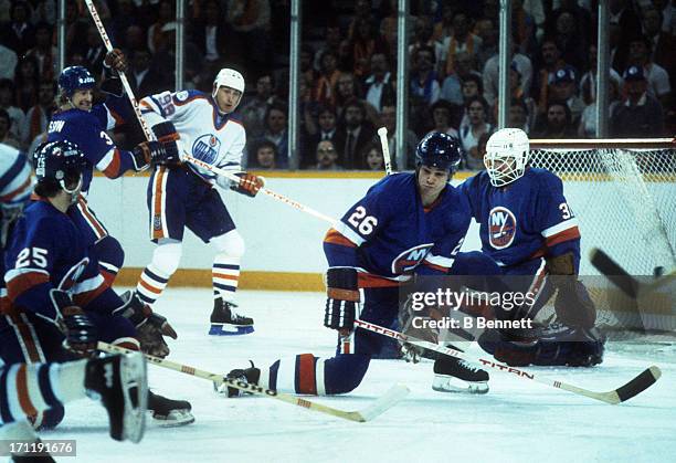 Dave Langevin of the New York Islanders tries to block a shot against the Edmonton Oilers during the 1984 Stanley Cup Finals in May, 1984 at the...