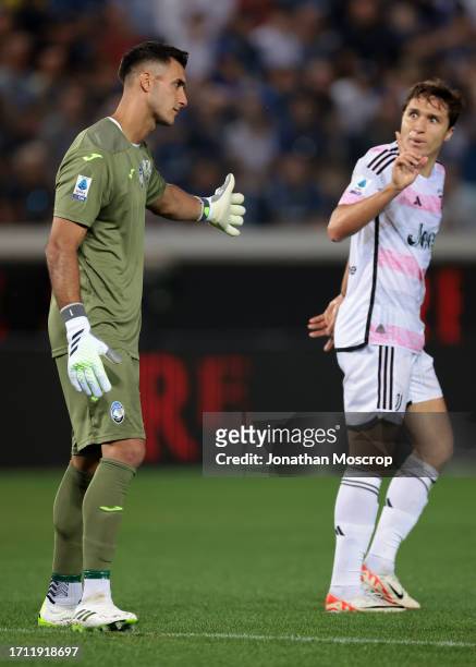 Federico Chiesa of Juventus discusses with Juan Musso of Atalanta during the Serie A TIM match between Atalanta BC and Juventus at Gewiss Stadium on...