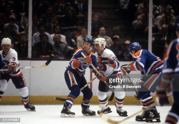 Ken Linesman of the Edmonton Oilers defends against Bryan Trottier of the New York Islanders during the 1984 Stanley Cup Finals in May, 1984 at the...