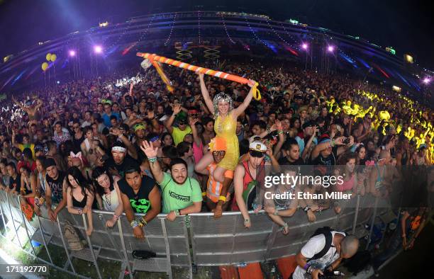 Lacy Knaffla of Nevada sits on the shoulders of Dave Levy of Nevada as they watch Empire of the Sun perform at the 17th annual Electric Daisy...