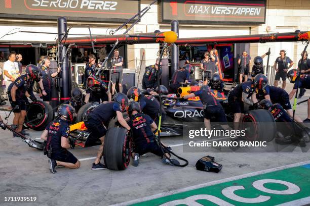 The pit crew works on Red Bull Racing's Dutch driver Max Verstappen's car during an extra practice session ahead of the Qatari Formula One Grand Prix...