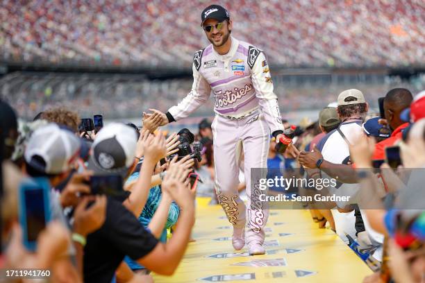 Daniel Suarez, driver of the Tootsies Orchid Lounge Chevrolet, greets fans as he walks onstage during driver intros prior to the NASCAR Cup Series...