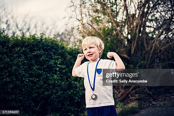 happy smiling little boy with a medal - stolz stock-fotos und bilder