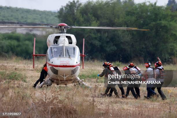 Graphic content / Israeli rescue teams evacuate a wounded person by helicopter near the southern city of Sderot on October 7 after the Palestinian...