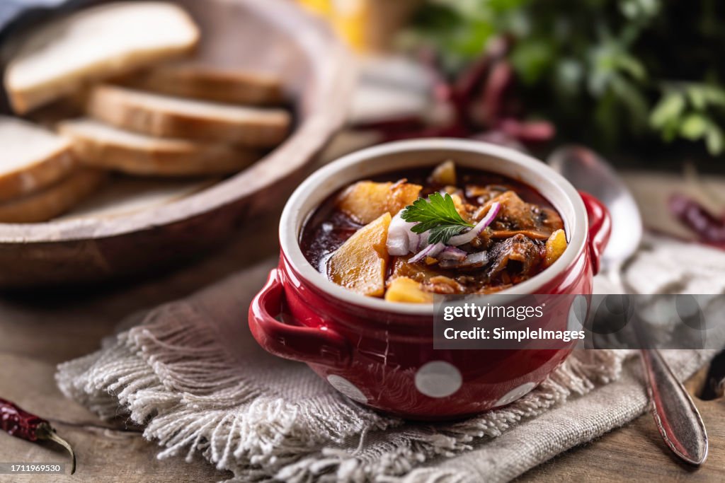 Traditional beef goulash served in a ceramic bowl on a table in a restaurant.