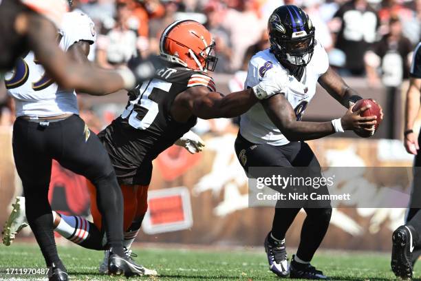 Myles Garrett of the Cleveland Browns attempts to tackle Lamar Jackson of the Baltimore Ravens during the second half at Cleveland Browns Stadium on...