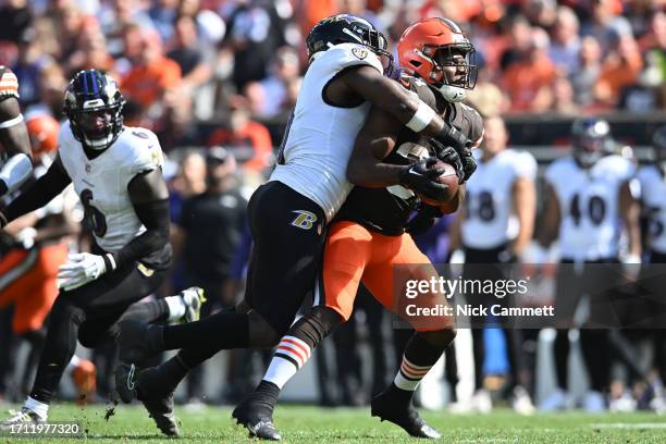 Roquan Smith of the Baltimore Ravens tackles Jerome Ford of the Cleveland Browns during the third quarter at Cleveland Browns Stadium on October 01,...