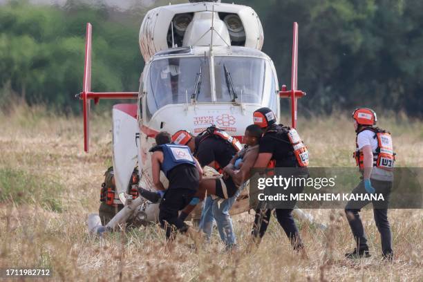 Graphic content / Israeli rescue teams evacuate a wounded person by helicopter near the southern city of Sderot on October 7 after the Palestinian...